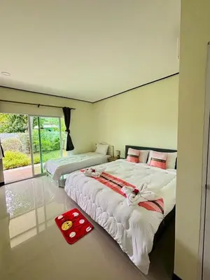 a bedroom with two beds and a large window at 3P Phuket Airport Hotel in Phuket