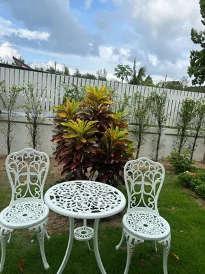 two chairs and a table and a table and chairs at 3P Phuket Airport Hotel in Phuket