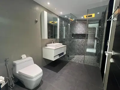 a bathroom with a toilet and a sink and a shower at Twin Sand Phuket by PPR in Patong Beach