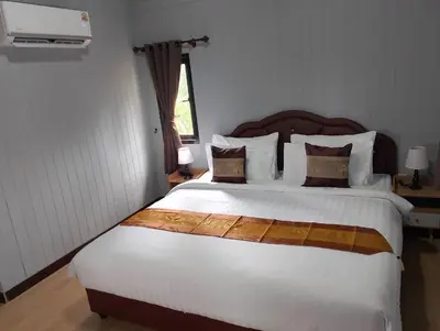 a bedroom with a large bed with white sheets and pillows at The white resort & restaurant koh yao yai in Ban Khlong Hia