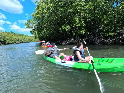 two people in a green kayak on a river at The white resort & restaurant koh yao yai in Ban Khlong Hia