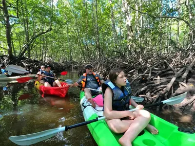 a group of people kayaking down a river at The white resort & restaurant koh yao yai in Ban Khlong Hia