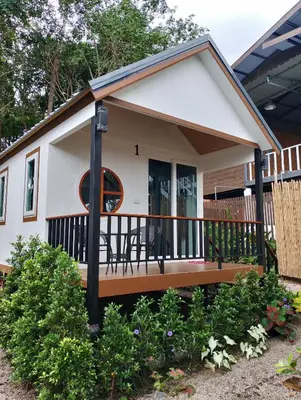 a tiny house with a porch and a deck at The white resort & restaurant koh yao yai in Ban Khlong Hia