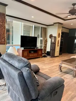 a living room with a couch and a flat screen tv at Karon Beach Seaview Penthouse With Private Pool Condominium in Karon Beach
