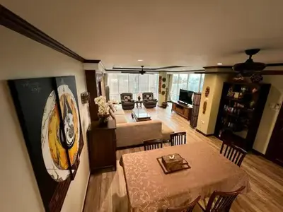 a living room with a table and a living room with a couch at Karon Beach Seaview Penthouse With Private Pool Condominium in Karon Beach