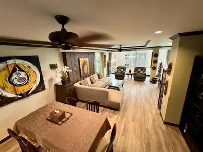 a living room with a couch and a table at Karon Beach Seaview Penthouse With Private Pool Condominium in Karon Beach