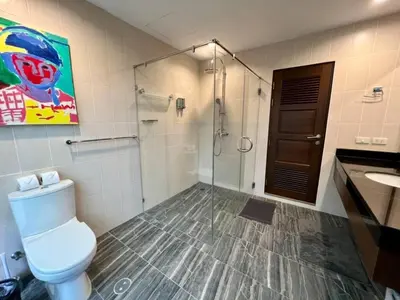 a bathroom with a toilet and a shower and a sink at Karon Beach Seaview Penthouse With Private Pool Condominium in Karon Beach