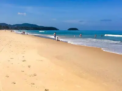 a group of people on a beach with the ocean at Karon Beach Seaview Penthouse With Private Pool Condominium in Karon Beach
