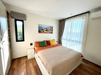 a bedroom with a large bed and a window at Halo 1 , 2 bedroom, 400m to the see in Nai Yang Beach