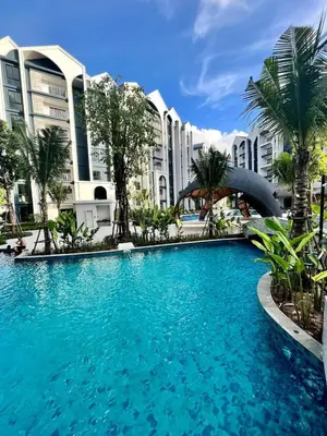 a large swimming pool in front of some buildings at Halo 1 , 2 bedroom, 400m to the see in Nai Yang Beach