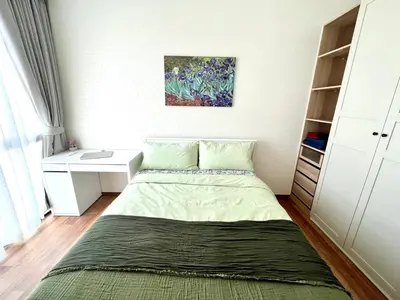 a small bedroom with a bed and a desk at Halo 1 , 2 bedroom, 400m to the see in Nai Yang Beach