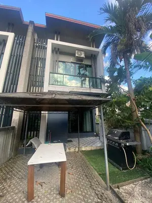 a house with a table and a grill in front of it at Town House in Ban Ket Ho