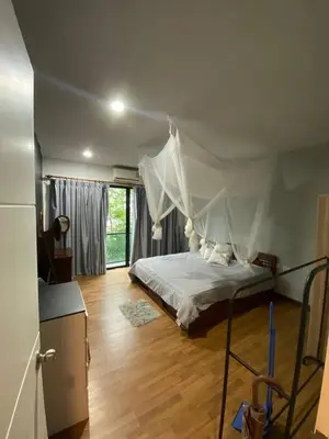 a bedroom with a bed with a mosquito net at Town House in Ban Ket Ho