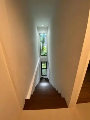 a staircase in a house with a window at Town House in Ban Ket Ho
