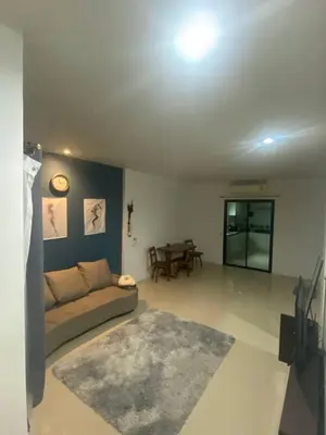 a living room with a couch and a table at Town House in Ban Ket Ho