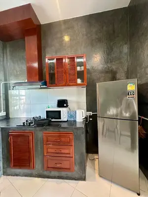 a kitchen with a stove and a refrigerator at Amazing Seaview House 2 Bedroom Patong in Patong Beach