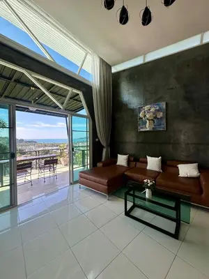 a living room with a couch and a table at Amazing Seaview House 2 Bedroom Patong in Patong Beach
