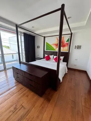 a bedroom with a large bed and a large mirror at Villa Rooftop in Ban Saiyuan (1)