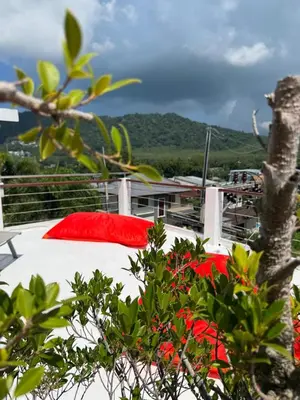 a bed on the deck of a ship with red pillows at Villa Rooftop in Ban Saiyuan (1)