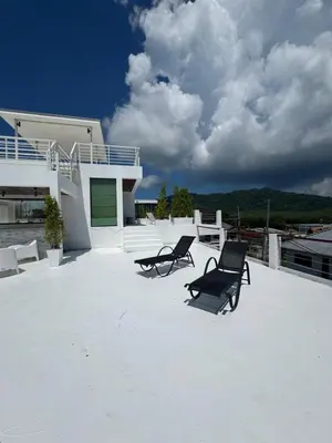 two chairs sitting on the roof of a house at Villa Rooftop in Ban Saiyuan (1)