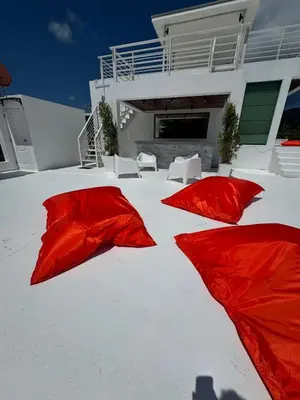two red umbrellas sitting in the snow in front of a house at Villa Rooftop in Ban Saiyuan (1)