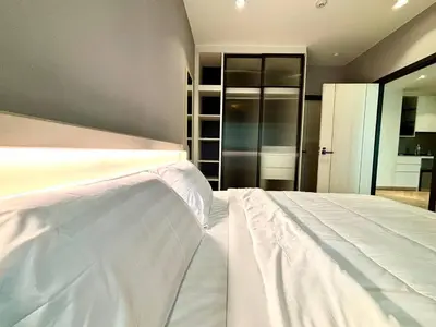 a large white bed in a room with at The Legendary Bang Tao 2-bedrooms apart #402 in Bang Tao Beach