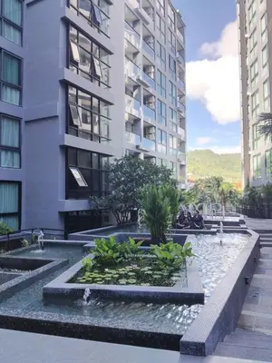 a building with a fountain in front of a building at Kamala City Gate 1 bedroom By Ere P710 in Kamala Beach