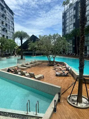 a swimming pool with lounge chairs in a hotel at Kamala City Gate 1 bedroom By Ere P710 in Kamala Beach