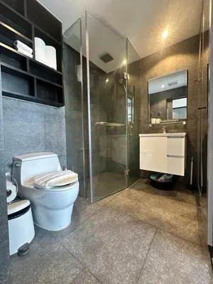 a bathroom with a toilet and a glass shower at Kamala City Gate 1 bedroom By Ere P710 in Kamala Beach