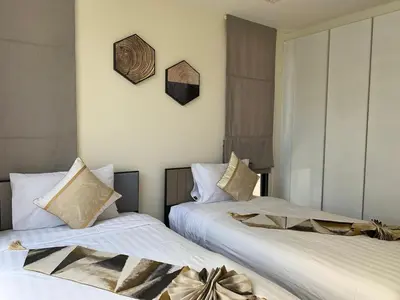 two beds sitting next to each other in a bedroom at Laguna Park 5 bedroom villa with pool in Laguna Phuket near the beach in Laguna Phuket