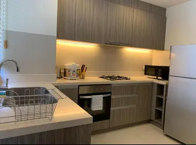 a kitchen with a stove and a refrigerator at Laguna Park 5 bedroom villa with pool in Laguna Phuket near the beach in Laguna Phuket