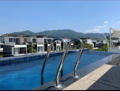 a swimming pool with two metal rails next to a building at Laguna Park 5 bedroom villa with pool in Laguna Phuket near the beach in Laguna Phuket