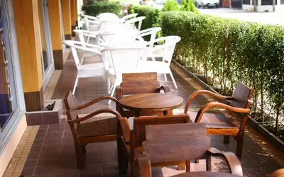 a row of tables and chairs on a patio at Breezotel - SHA Certified in Patong Beach