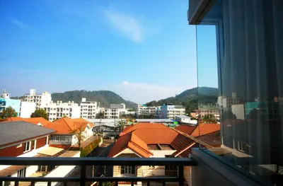 a view of a city from a balcony at Breezotel - SHA Certified in Patong Beach