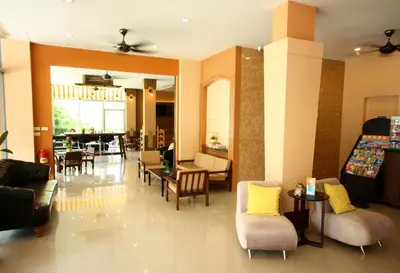 a lobby with chairs and tables and a dining room at Breezotel - SHA Certified in Patong Beach