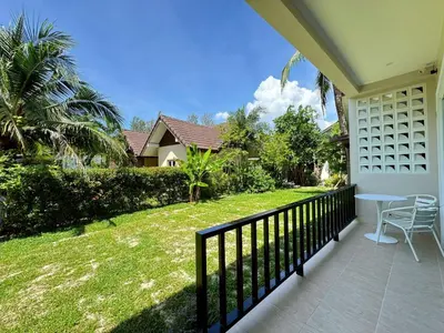 a balcony of a house with a table and chairs at The Pinda House Bangtao in Bang Tao Beach