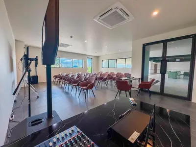 a large room with chairs and tables and a stage at La Vita 5 star Super 1 Bdr Nai Harn Beach in Rawai Beach