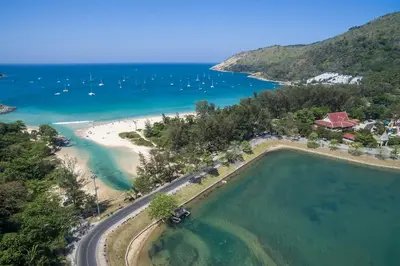 an aerial view of a beach with boats in the water at The Lago Nai Harn 2 BR-Walk to beach by ALL HOMES in Rawai Beach