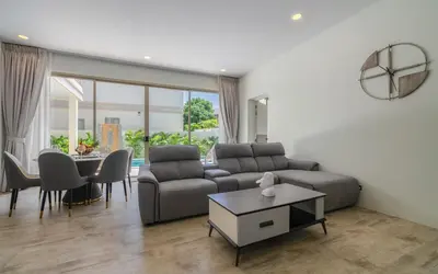 a living room with a couch and a table at Villa Orion at Orbita Villas Rawai in Rawai Beach