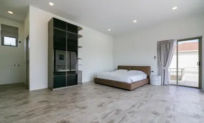 a bedroom with a bed and a sliding glass door at Villa Orion at Orbita Villas Rawai in Rawai Beach