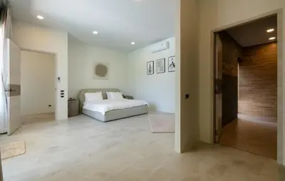 a bedroom with a white bed and a hallway at Villa Orion at Orbita Villas Rawai in Rawai Beach