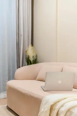 a laptop computer sitting on a couch in a living room at Zcape 1 By SilqStay in Ban Thalat Choeng Thale