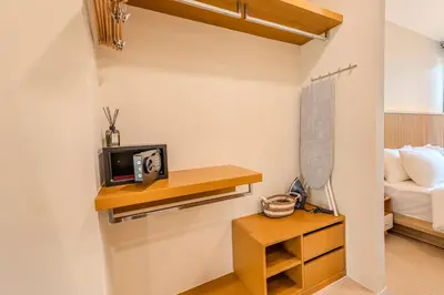 a room with a bed and a table with a microwave at Zcape 1 By SilqStay in Ban Thalat Choeng Thale