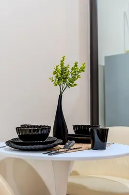a white table with plates and a vase on it at Zcape 1 By SilqStay in Ban Thalat Choeng Thale