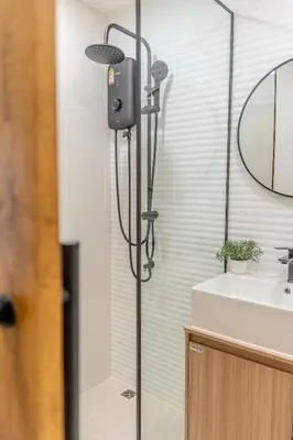 a bathroom with a shower with a mirror and a sink at Zcape 1 By SilqStay in Ban Thalat Choeng Thale