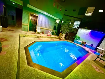 a large swimming pool in the middle of a house at Hill Side Patong in Patong Beach