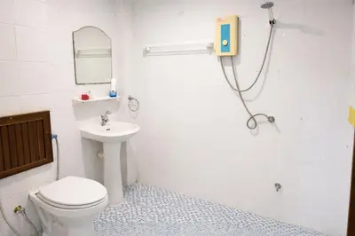 a bathroom with a shower and a toilet and a sink at Hill Side Patong in Patong Beach
