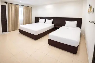 a bedroom with two beds with white sheets at Hill Side Patong in Patong Beach