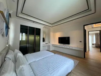 a bedroom with a bed and a flat screen tv at Вилла на Бангтао in Ban Thalat Choeng Thale