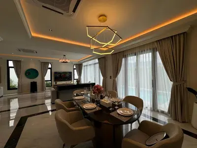 a living room with a dining room table and chairs at Вилла на Бангтао in Ban Thalat Choeng Thale